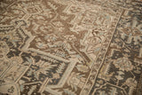 Worn low pile showing knot heads through coffee brown and powder blue geometric patterns.