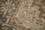 Detail of the distressed Heriz carpet's border showing mostly even wear to the pile.