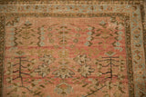 Unusual boteh border in powder blue and bronze on a distressed dusty blush vintage Sarouk rug.