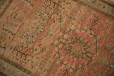 Distressed low pile of a vintage Persian Sarouk with interconnecting floral and vinery motifs.