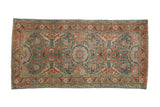 Vintage distressed Malayer rug with a central floral medallion and scrolling vines in sky blue, red, and silver tones.