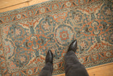 The decorative, time-softened texture of a vintage Persian Malayer rug runner.