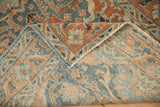Close-up of the vintage rug's hand-knotted back and secured powder blue side cord selvage.