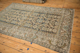 A full view of the vintage Hamadan rug, showing color abrashes across its dusty blue Herati pattern.