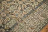Close-up of the vintage Hamadan rug's serrated leaf border and dusty teal Herati field.