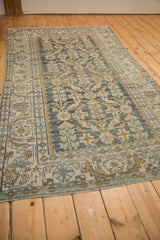 A full perspective of the distressed Herati field in dusty teal and earthen tones.