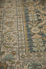 Distressed Hamadan rug's ivory border beside the dusty teal and moss green Herati patterned field.