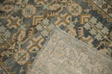 A flipped corner of the vintage Hamadan rug reveals its tight hand-knotted foundation.