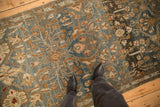 View from above showing the distressed low pile and floral pattern of a vintage Malayer runner.