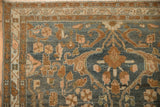 Corner of a distressed Persian Malayer showing the boteh border and evenly worn floral field.