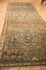 Angled full-length view of the distressed Persian runner, highlighting its color abrashes.
