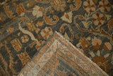 Folded corner of a vintage Malayer runner revealing its hand-knotted foundation and restored side cord.