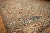 Angled view of a vintage Bakhtiari carpet's corner spandrels and floral borders.