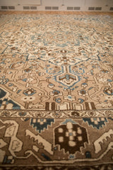 A low perspective of the distressed carpet's intricate floral vine and border design.