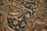 Detailed weave of a distressed Bakhtiari rug with dusty blue and coffee brown motifs.
