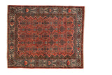 Vintage Persian Malayer rug with an allover floral and quatrefoil pattern on a brick red field.