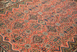 Angled view of the vintage Malayer rug's low pile and visible hand-knotted texture.