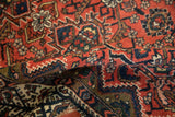 Dense, hand-knotted pile of a vintage Malayer rug with brick red and navy blue geometric floral patterns.