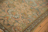 Angled view of expressive blossoms and boteh paisley on the rug's distressed pile.