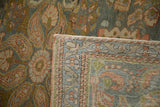 The back of the distressed Persian rug showing the hand-knotted foundation and floral weave.