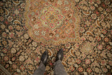 Time-softened texture on the vintage Sivas carpet's floral medallion and Herati field.