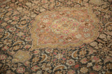 A close view of the distressed Sivas carpet's mahi-mahi design and blush central medallion.