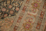 Distressed texture contrasting the charcoal Herati pattern with the dusty blush and saffron floral border.
