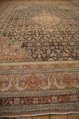 Intricate floral borders and Herati design viewed down the length of a distressed Sivas carpet.