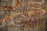 Angled view of the worn texture and mahi-mahi Herati design on a vintage Sivas rug.