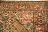 Corner of a distressed Bakhtiari rug with its brick red paisley boteh and lotus flower border.