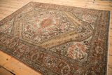 Vintage Persian Bakhtiari rug viewed from an angle, highlighting its soft wear and earthen palette.