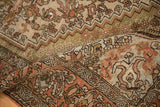 Worn low-pile texture on a vintage Bakhtiari rug with visible paisley boteh and floral patterns.