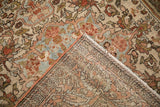 Folded corner of a distressed Bakhtiari rug showing its hand-knotted foundation and worn pile.