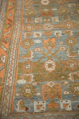 Evenly worn texture of a vintage Mehreban rug's geometric Herati design and vine border.