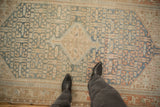 Scale and low-pile texture of a distressed Malayer rug in sky blue and sand.