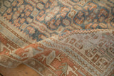 Softly worn hand-knotted texture of a distressed Malayer rug with sky blue and sand tones.