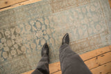 Distressed vintage Malayer runner showing time-softened texture in powder blue and beige tones.