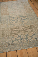 Angled view of the vintage Malayer runner highlighting its distressed, low-pile texture and muted tones.