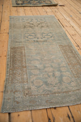 Distressed Malayer runner viewed down its length, showing the soft blue and beige Herati pattern.