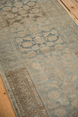 Close view of the vintage Malayer runner's curvilinear border and low, distressed pile.