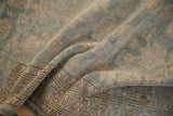 Low pile texture and meandering vine border detail on a distressed hand-knotted Malayer runner.