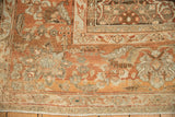 Corner detail of a vintage Malayer rug showing the floral palmette border and evenly worn pile.