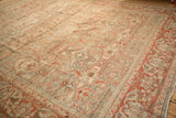 Angled perspective on the distressed Malayer carpet's even wear and low, hand-knotted pile.