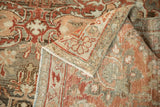 Folded corner of a vintage Malayer rug showing its hand-knotted back and evenly worn pile.