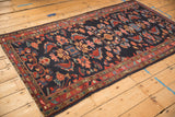 High-angle view down the length of a vintage Persian Mehreban rug showing its intricate floral pattern.
