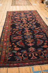 Vintage Mehreban rug shown at an angle, highlighting its deep navy field and traditional allover pattern.
