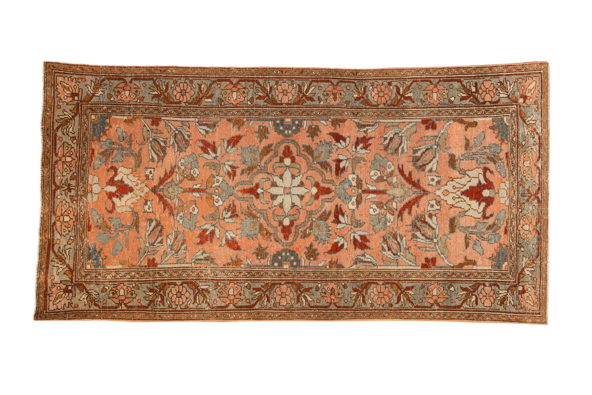 Vintage distressed Lilihan runner with a central starburst medallion in blush, slate blue, and pomegranate red.
