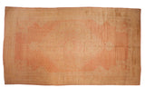 Vintage distressed Oushak carpet with tremendous oversized medallion, soft rose, gold, and ivory floral patterns.