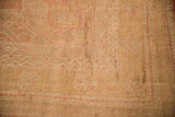 Soft pile texture with dusty blush simplistic floral patterns on a distressed Oushak rug.