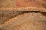 Distressed Oushak carpet pile showing worn texture with faded rose and pale gold tones.